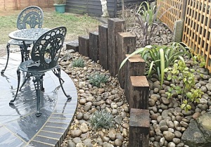 THE ROCKERY GARDEN WITH THE ROUND PATIO AND WOODEN CONSTRUCTION 